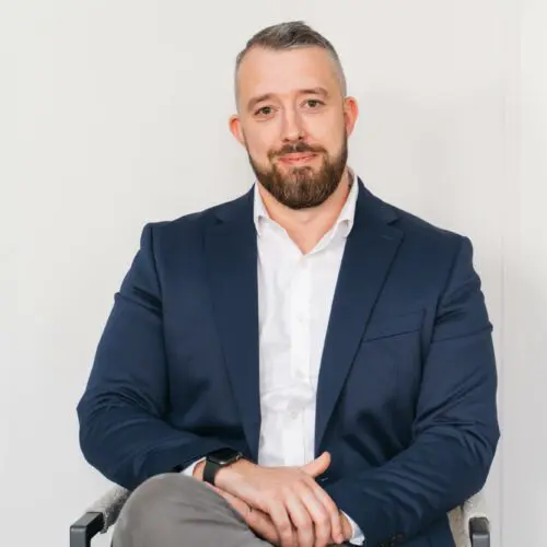 Man in suit sitting confidently