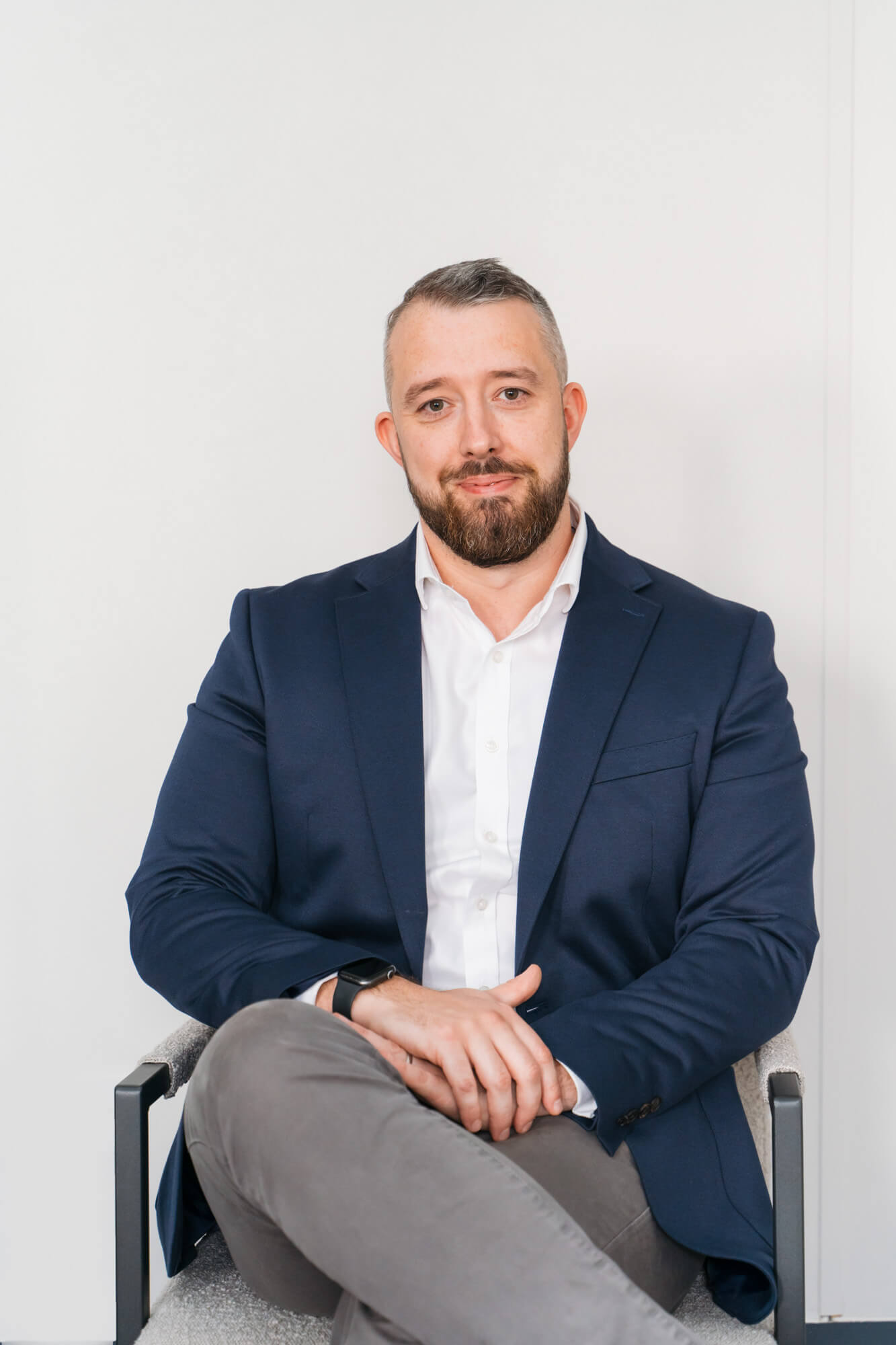 Man in suit sitting confidently