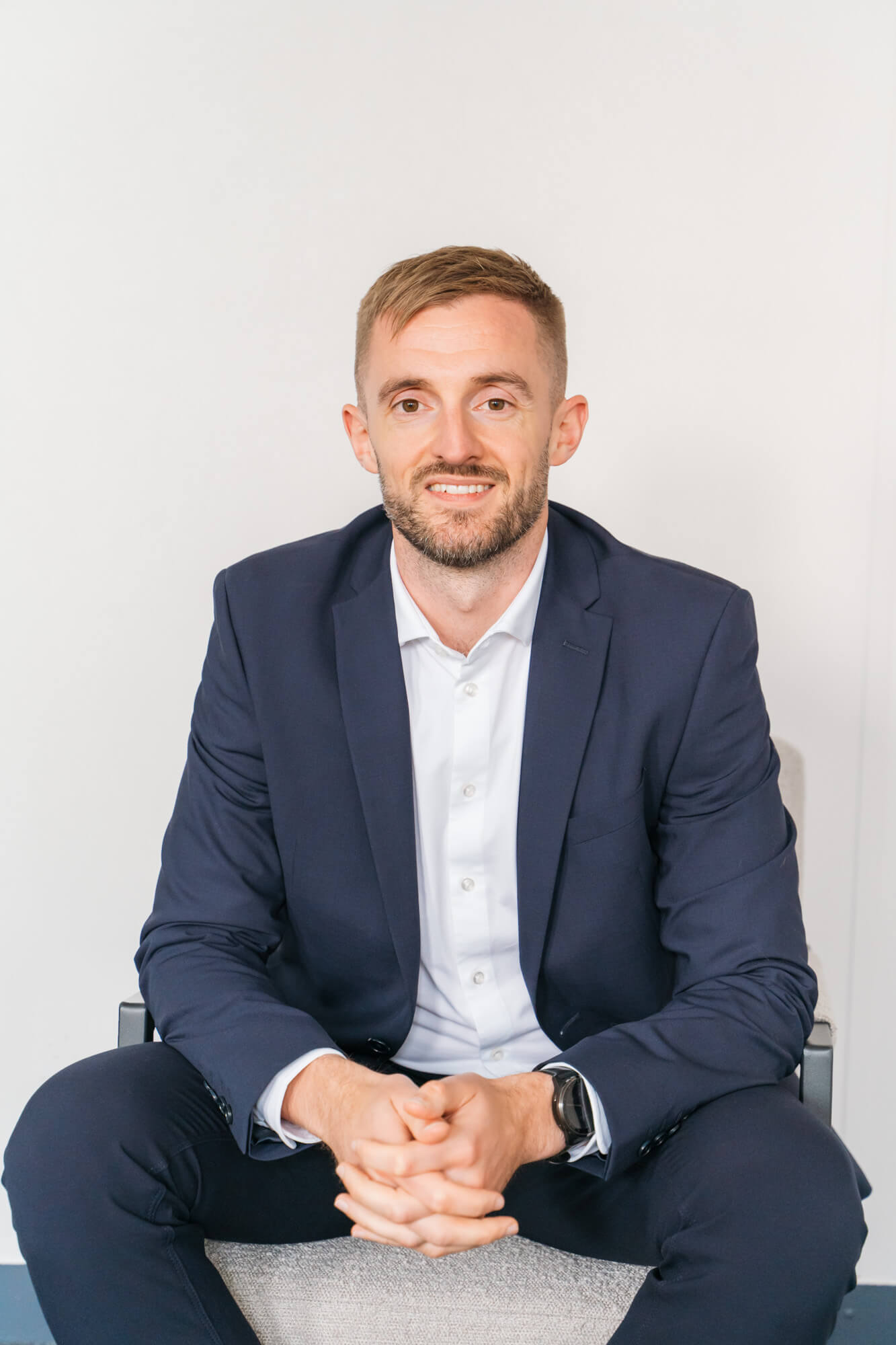 Man in suit sitting confidently