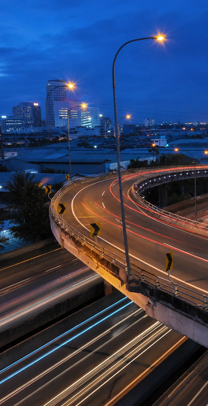 Nighttime highway with city skyline